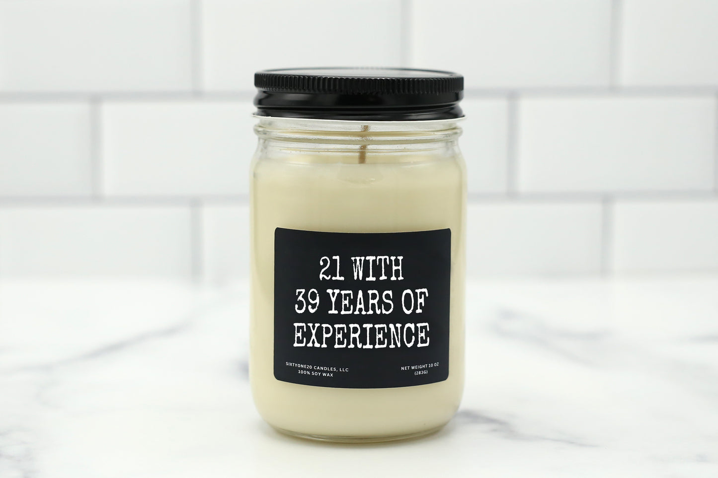 A 10 oz handmade soy wax candle with the label "21 with 39 years of experience," perfect for milestone birthday gifts, available in 10 scents.