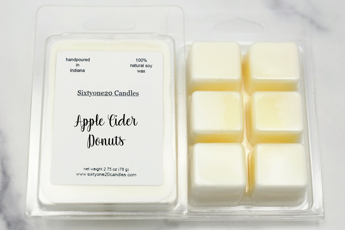 Apple Cider Donuts soy wax melts in clamshell packaging, labeled and shown on marble surface