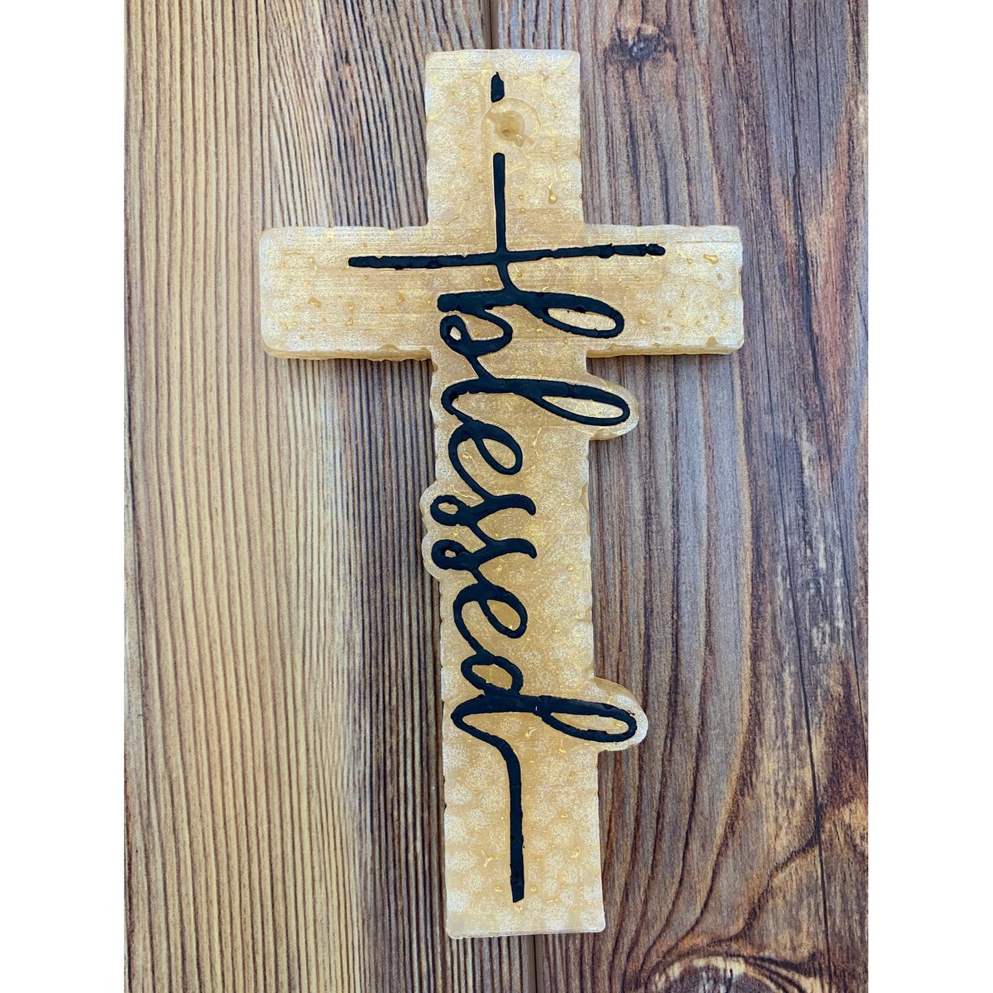 Gold cross-shaped freshie with the word ‘blessed’ in black script, a meaningful car accessory for faith-filled spaces or thoughtful gifts