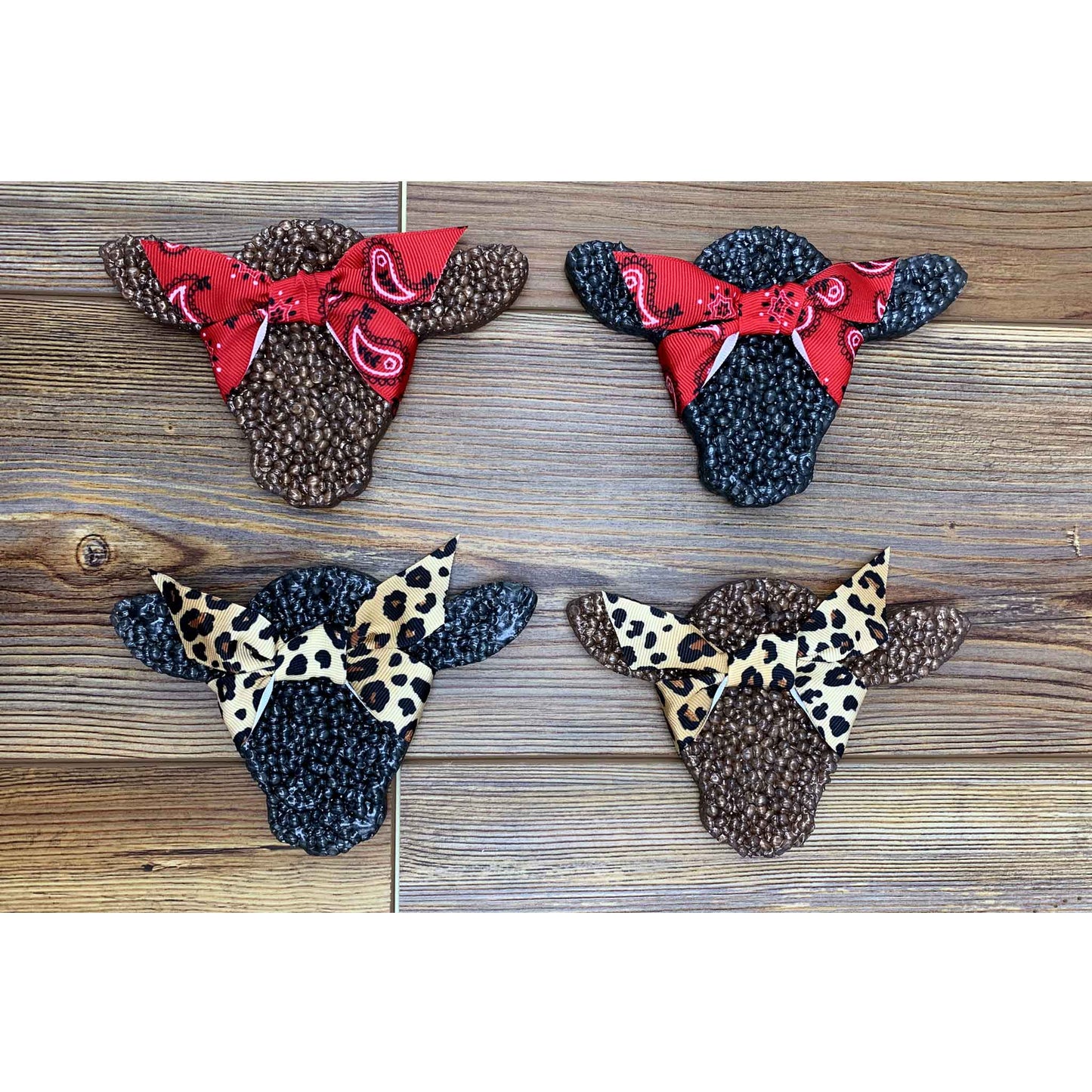 Four cow head car freshies with decorative bows in red bandana or leopard print, handmade by Sixtyone20 Candles.