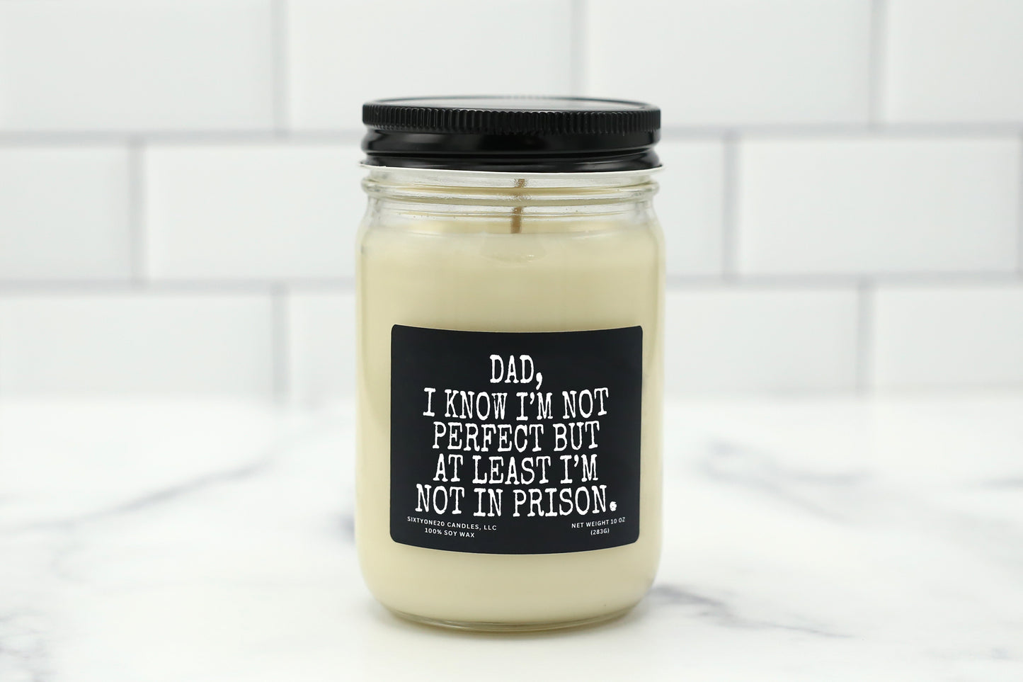 A 10 oz handmade soy wax candle with the label "Dad, I Know I’m Not Perfect but at Least I’m Not in Prison"—a funny Father’s Day gift available in 10 custom scents.