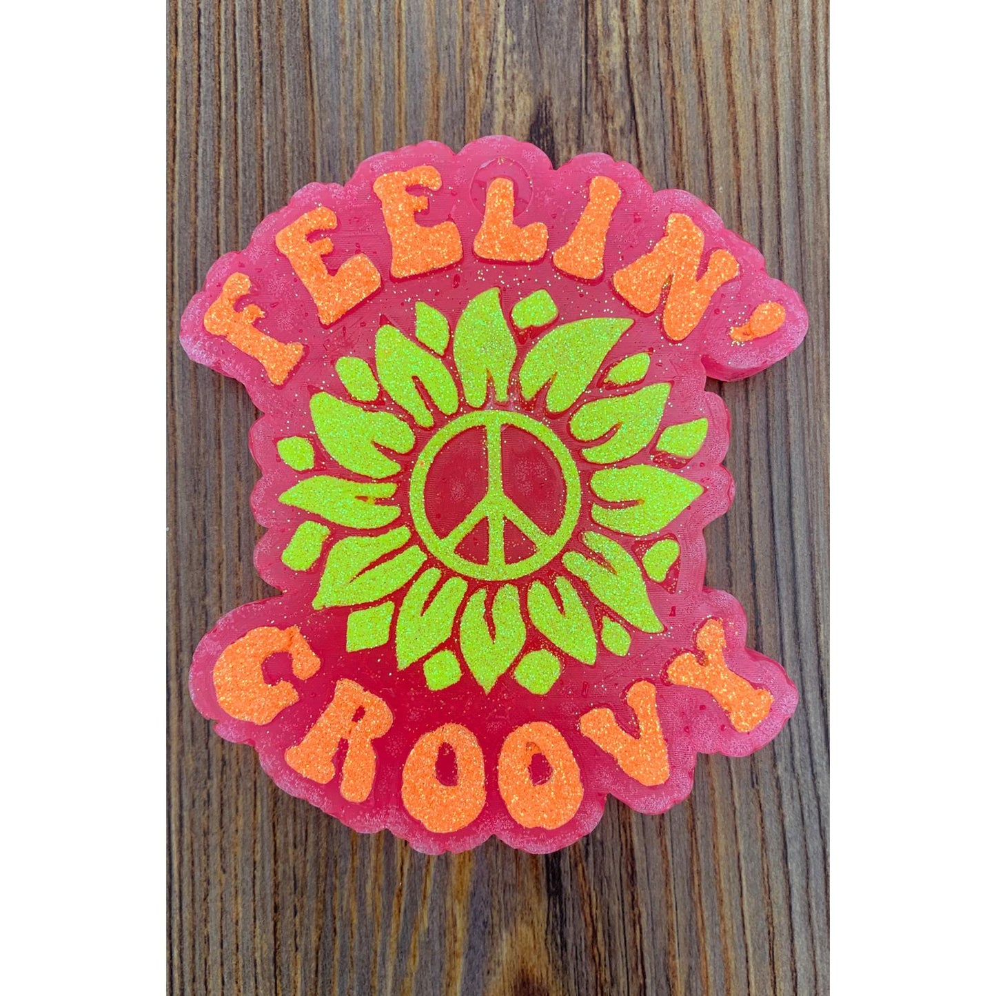 Feelin’ Groovy” in bold orange letters—perfect for the flower child at heart or anyone who loves a little retro charm in their ride.
