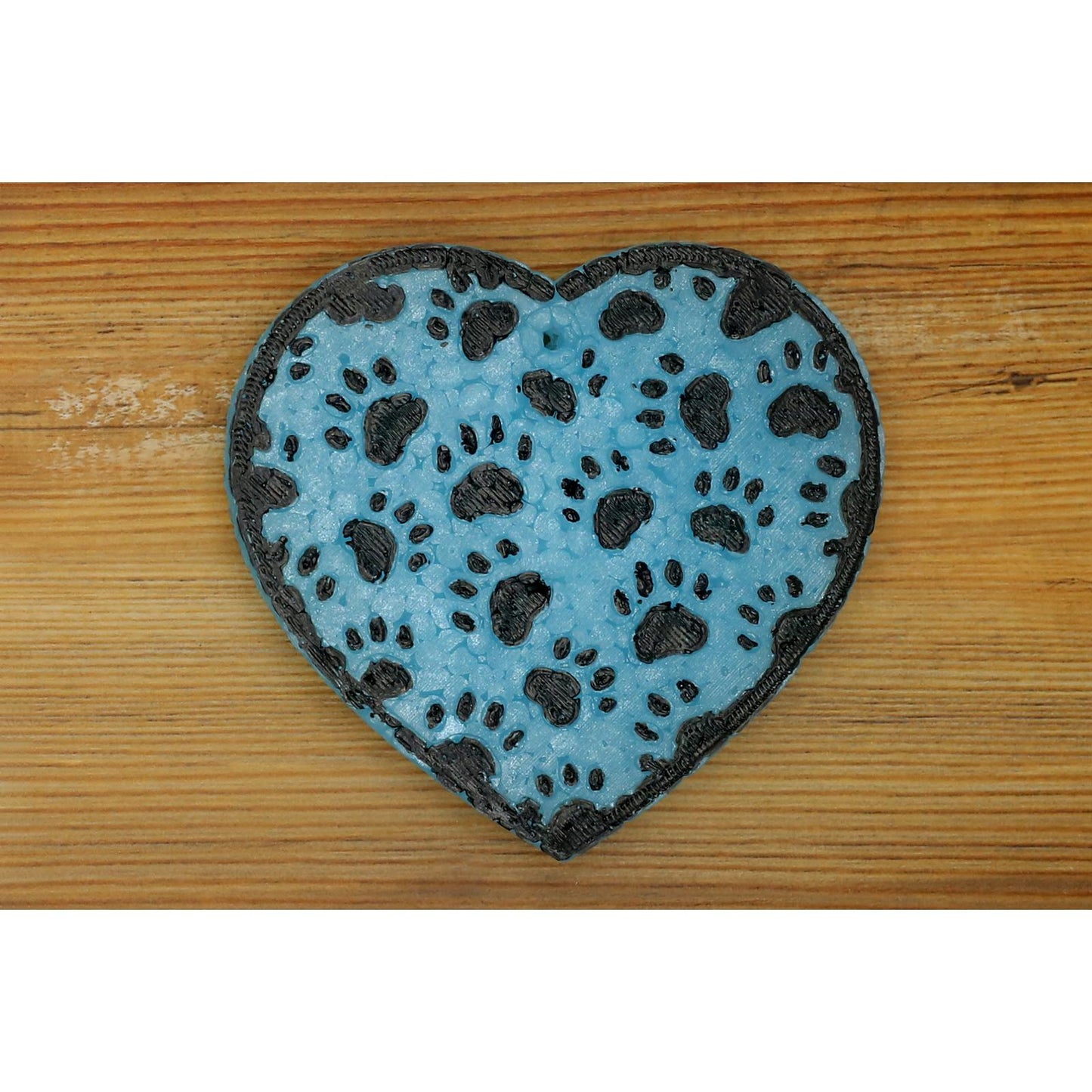 blue heart-shaped car freshie with black paw prints on wood background