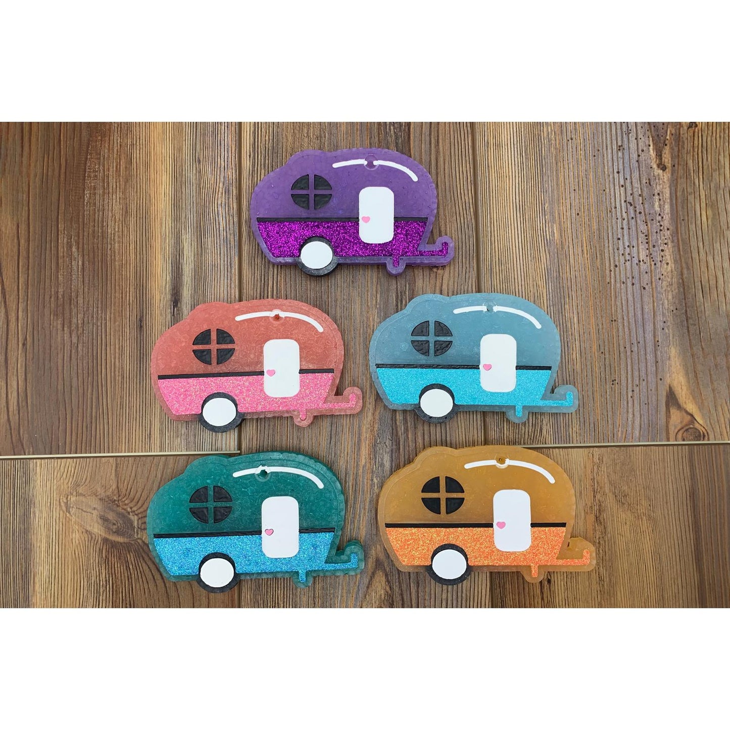 Colorful vintage camper-shaped car freshies available in multiple color combos, perfect for RV lovers and outdoor adventurers