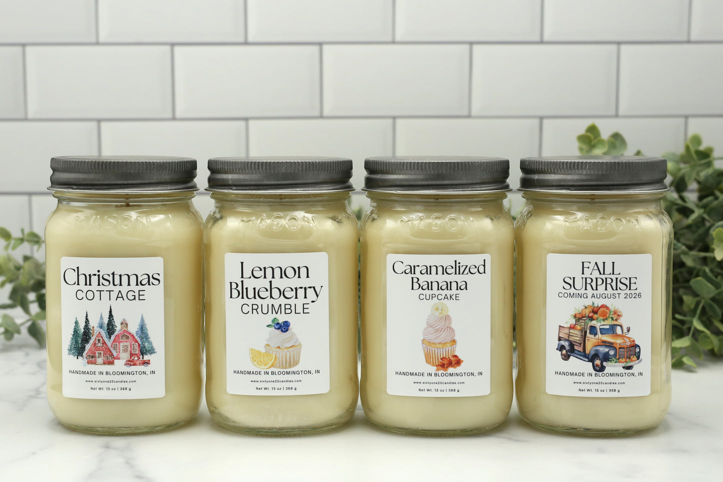 Four Candle Club exclusive 16 oz mason jar candles including Christmas Cottage, Lemon Blueberry Crumble, Caramelized Banana Cupcake, and Fall 2026 surprise fragrance.