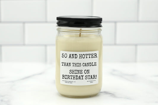 A 10 oz handmade soy wax candle with the label "50 and Hotter Than This Candle - Shine On Birthday Star," perfect for milestone birthday gifts, available in 10 scents.