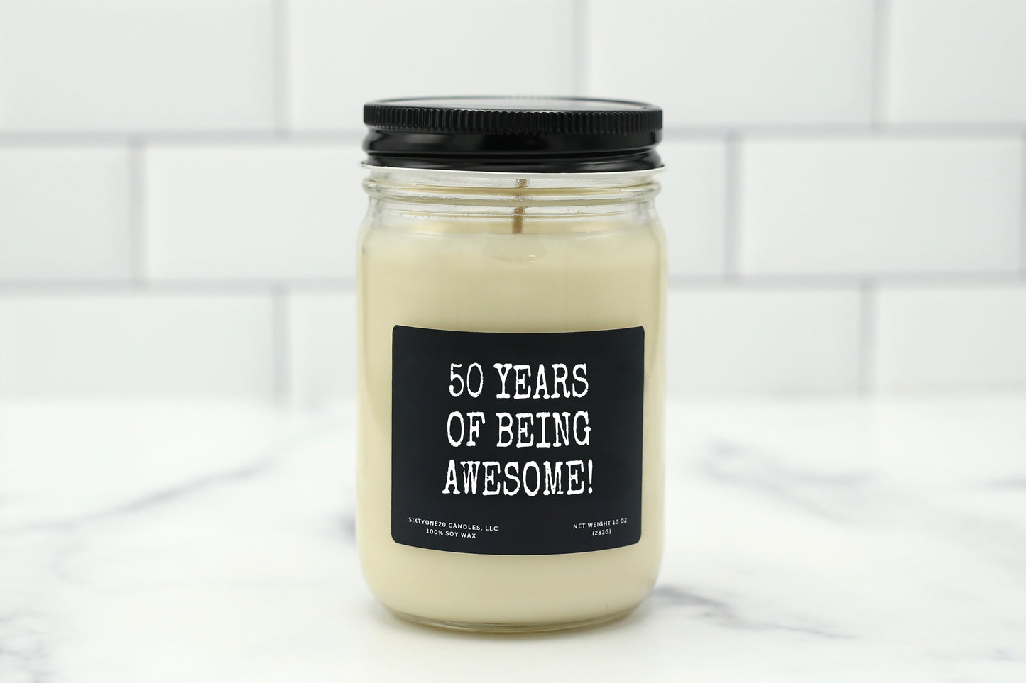 A 10 oz handmade soy wax candle with the label "50 Years of Being Awesome!"—a fun, celebratory birthday gift available in 10 scent options.