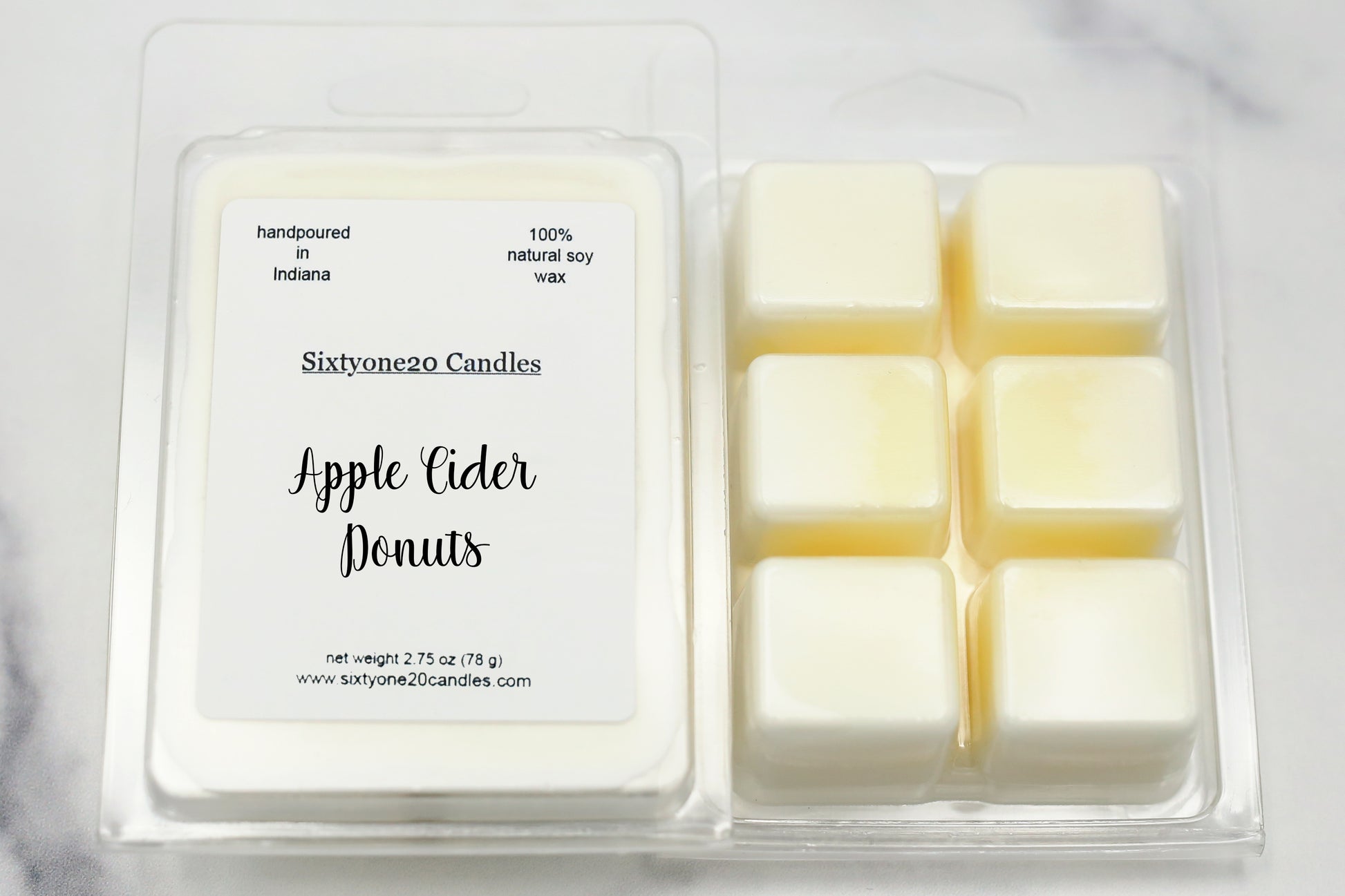 Apple Cider Donuts soy wax melts in clamshell packaging, labeled and shown on marble surface