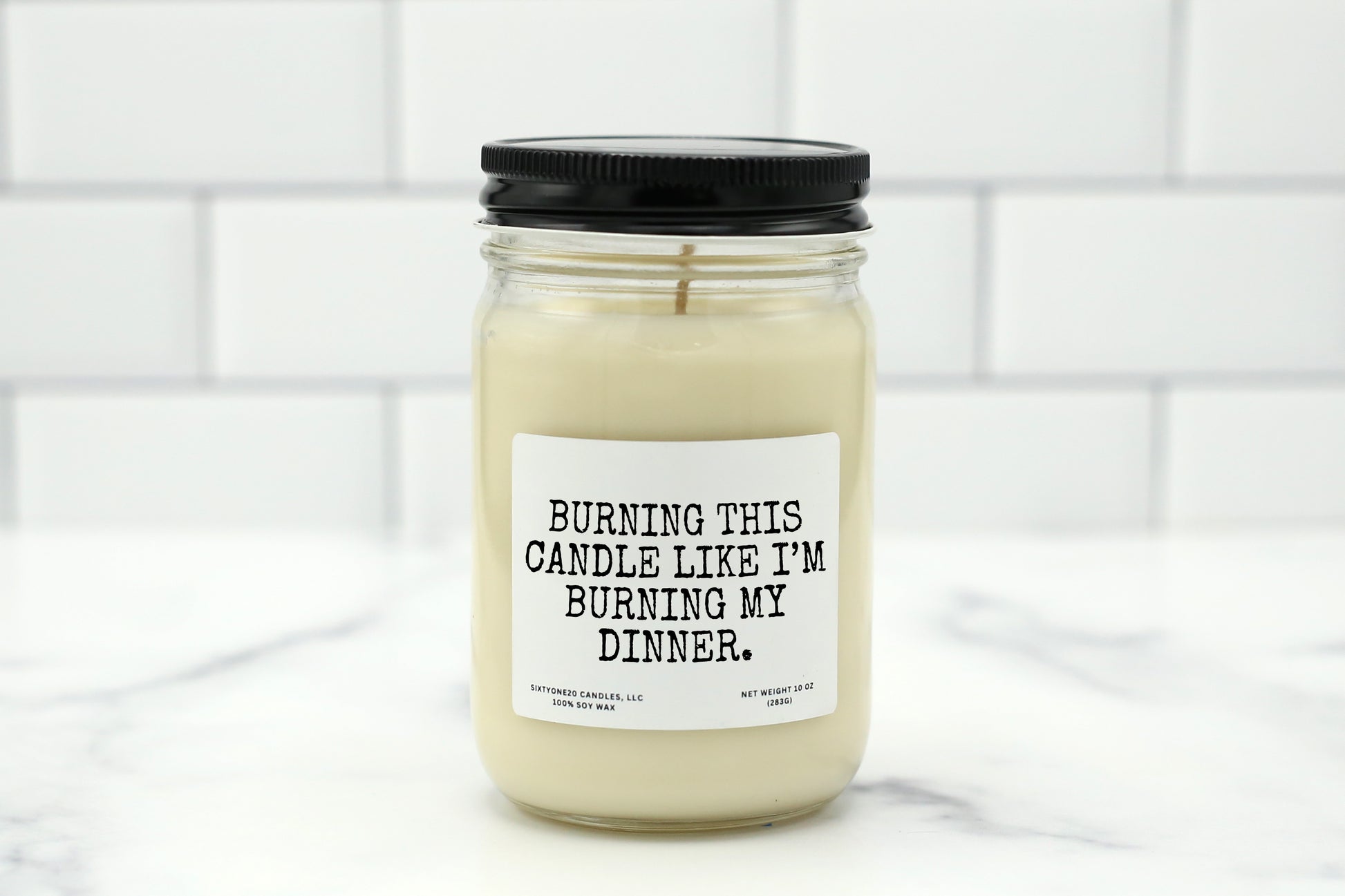 A 10 oz handmade soy wax candle with the label "Burning This Candle Like I’m Burning My Dinner"—a funny gift available in 10 custom scents, perfect for housewarmings, birthdays, or kitchen decor.