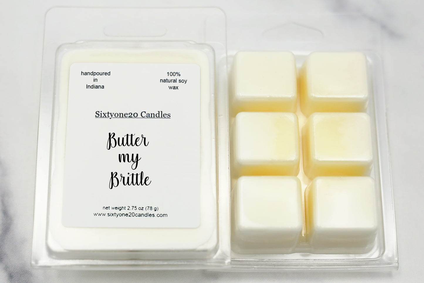 Butter My Brittle soy wax melts in clamshell packaging with six wax cubes and labeled front panel, displayed on white marble