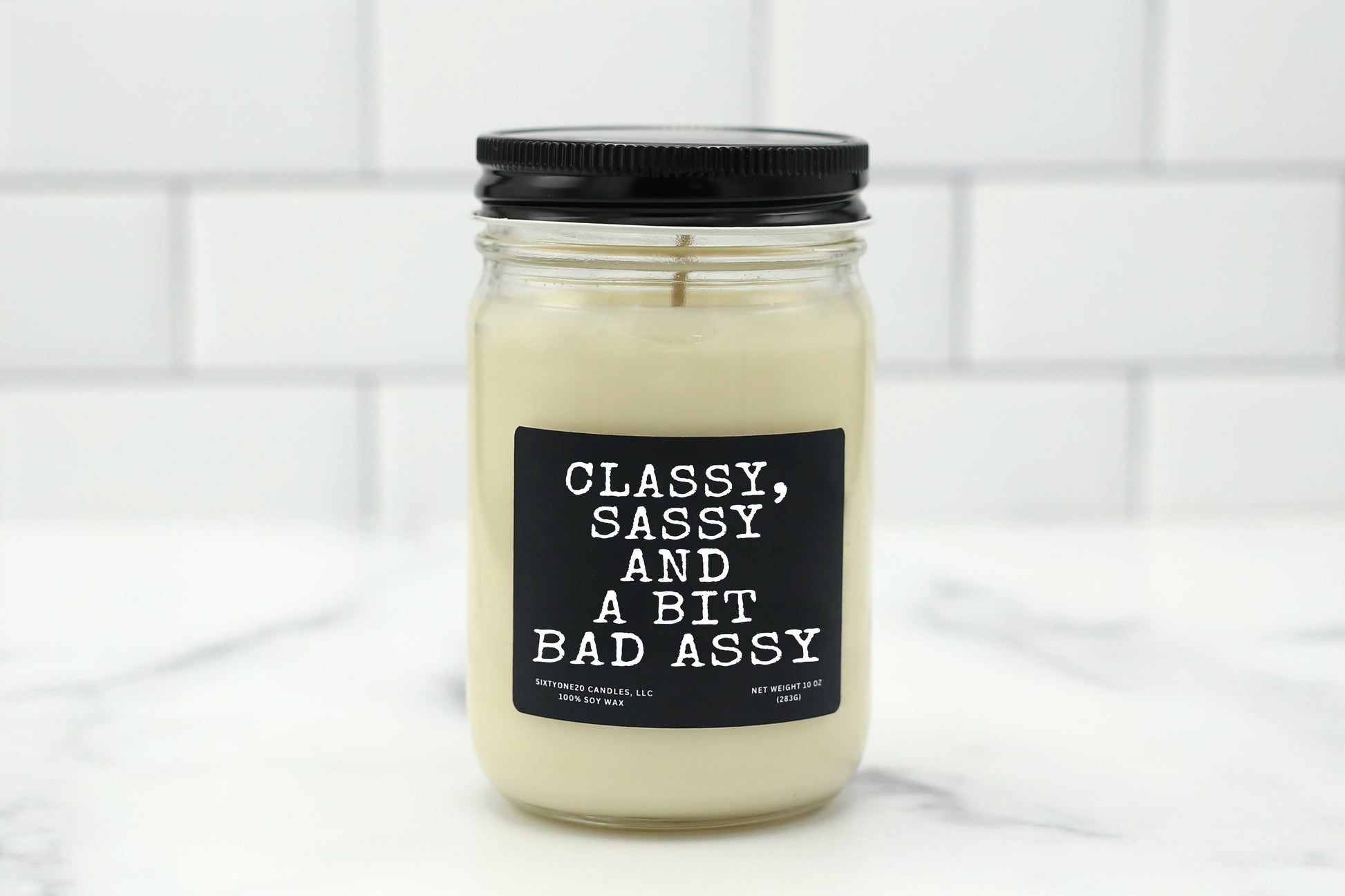 A 10 oz handmade soy wax candle with the label "Classy, Sassy, and a Bit Bad Assy"—a funny gift available in 10 custom scents, perfect for birthdays, promotions, or Galentine’s Day.