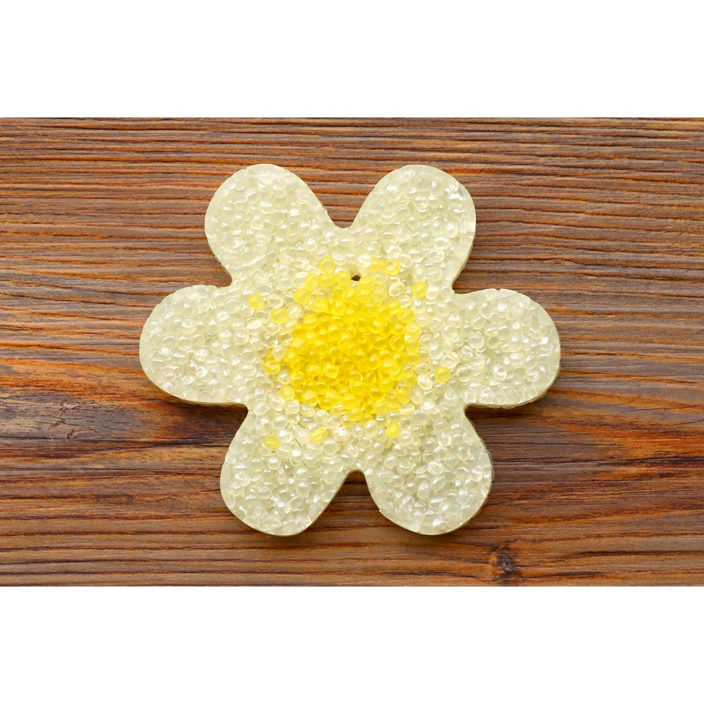 white daisy flower freshie with yellow center on wood background