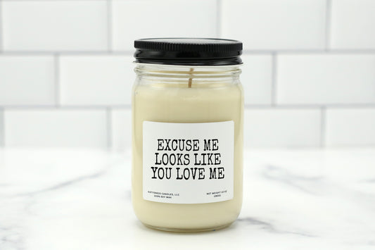 10 oz personalized candle with the saying 'Excuse me, looks like you love me,' available in various scents, made with natural soy wax.