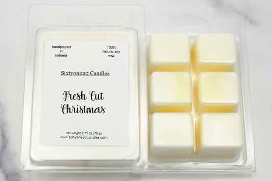 Sixtyone20 Candles soy wax melt labeled Fresh Cut Christmas, displayed on a clean white background. Handmade melt in a clear plastic clamshell from Sixtyone20 Candles, Bloomington, Indiana.