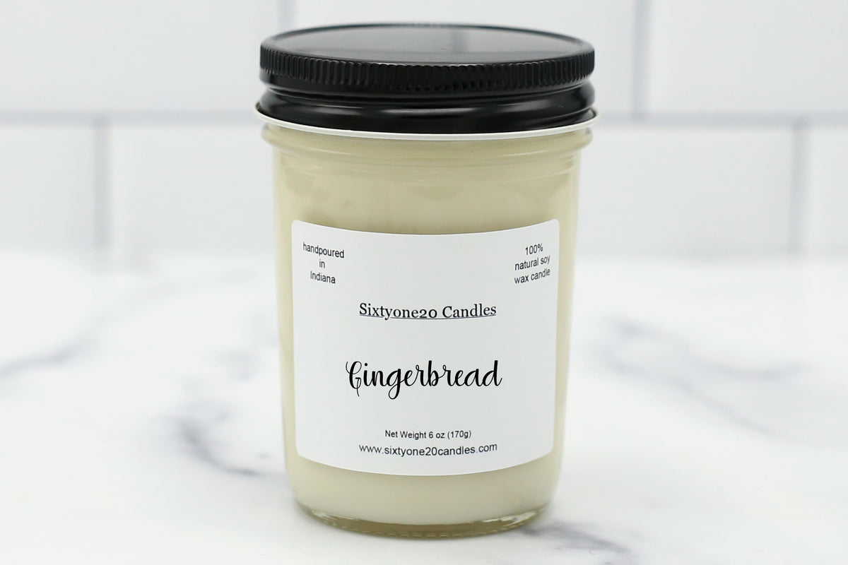 Sixtyone20 Candles 8 oz soy candle labeled Gingerbread, displayed on a clean white background. Hand-poured candle in a clear jelly jar with black lid from Sixtyone20 Candles, Bloomington, Indiana.