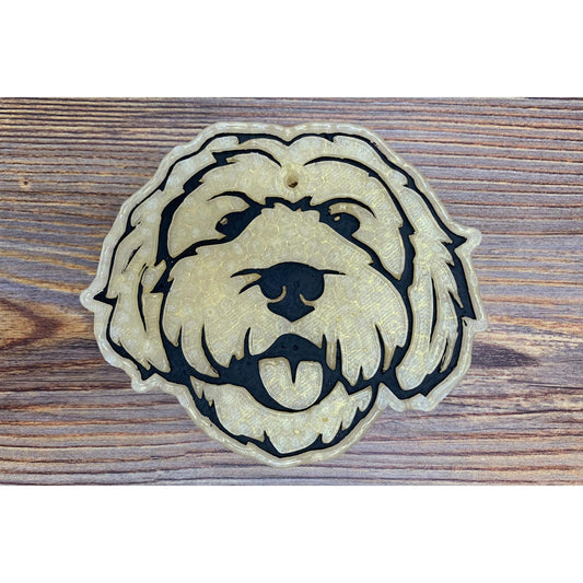 goldendoodle dog face freshie with curly fur detail on wood background