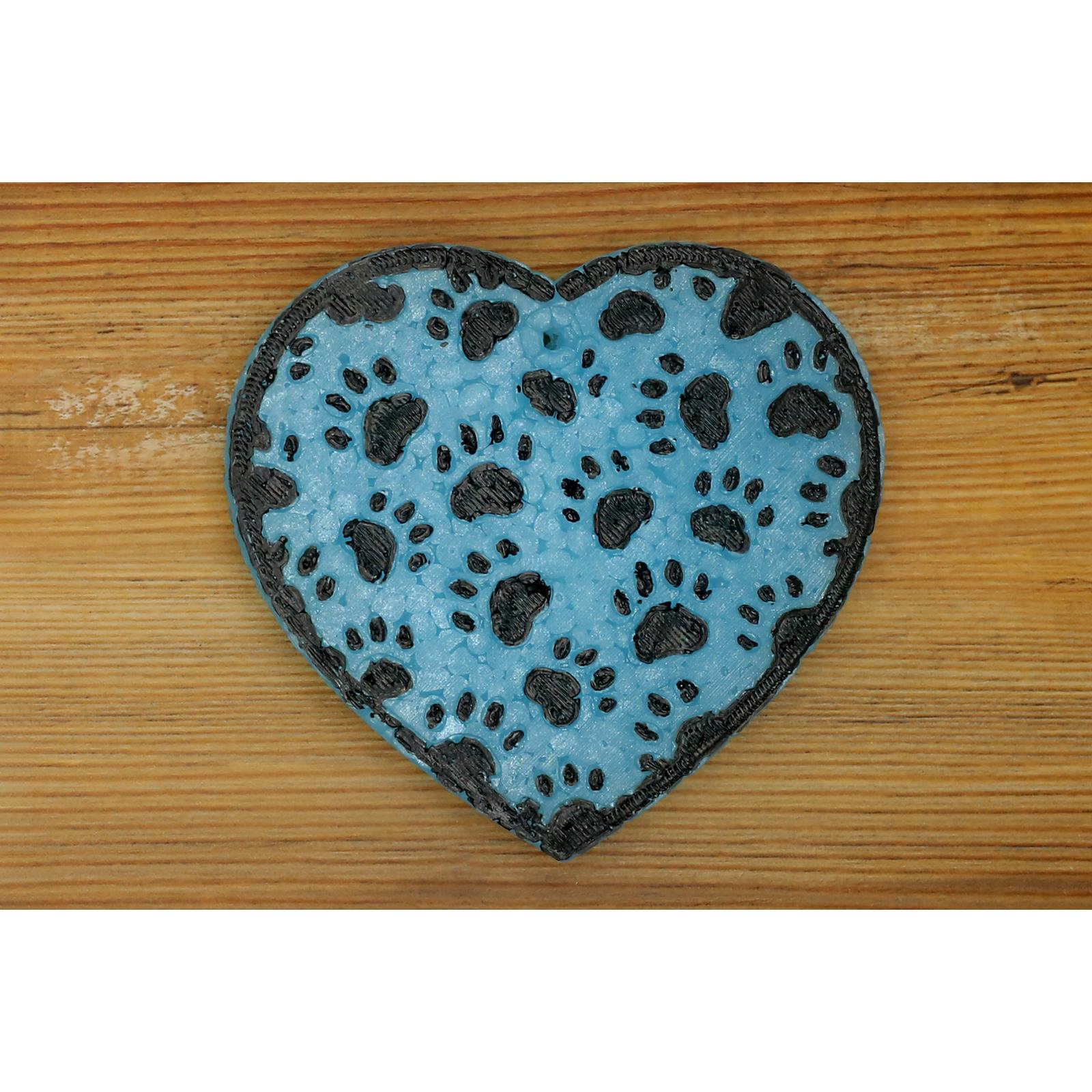 blue heart-shaped car freshie with black paw prints on wood background