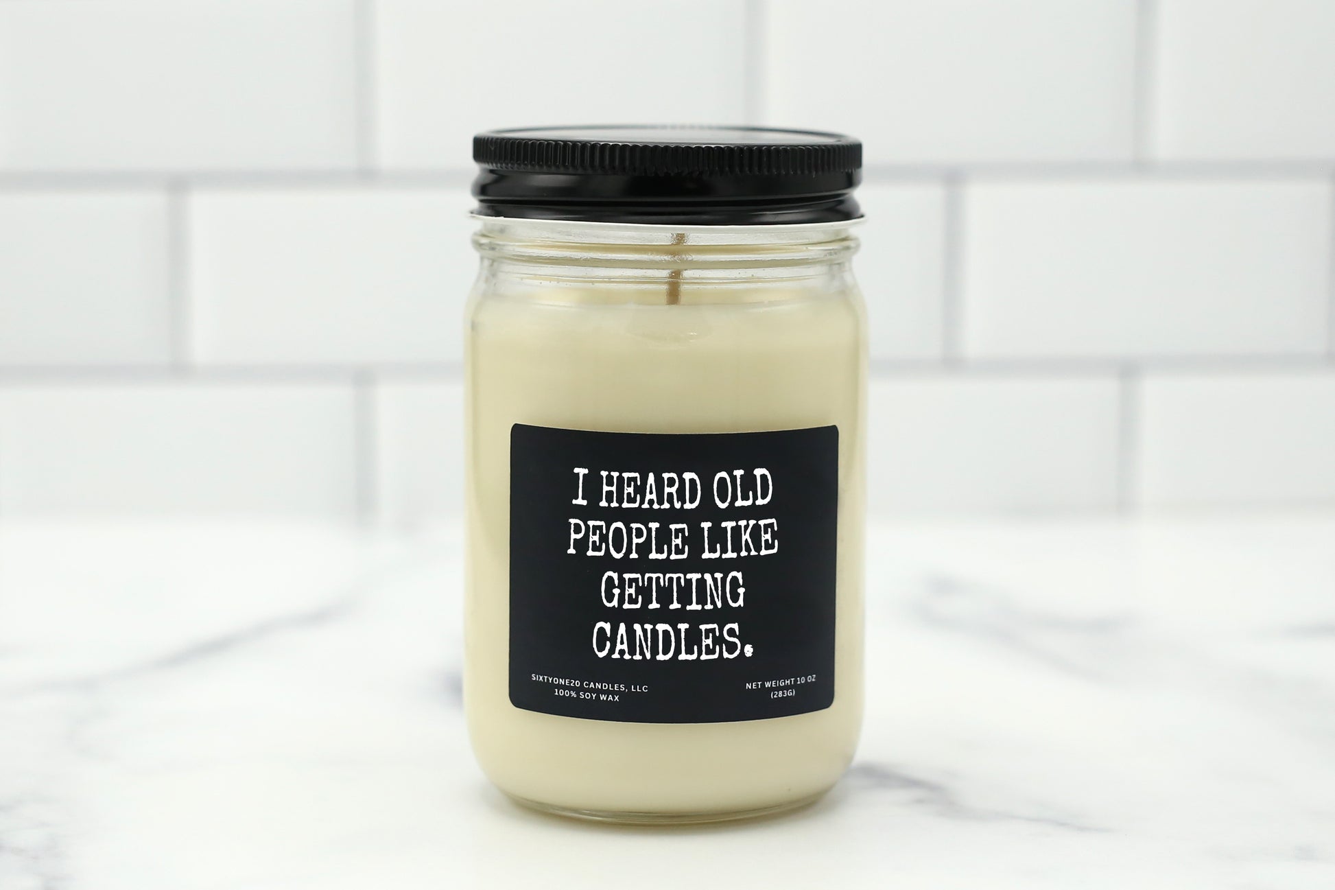 A 10 oz handmade soy wax candle with the label "I Heard Old People Like Getting Candles"—a funny birthday gift available in 10 custom scents, great for milestone birthdays or over-the-hill celebrations.