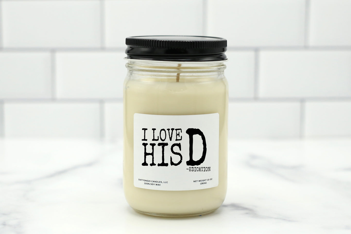 Soy wax candle with the label "I Love His D (edication)" – a funny, playful gift for couples.