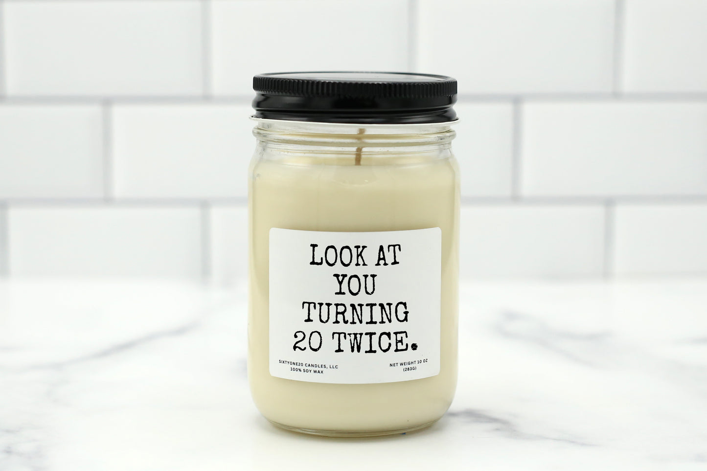 A 10 oz handmade soy wax candle with the label "Look at You Turning 20 Twice"—a funny 40th birthday gift available in 10 custom scents.