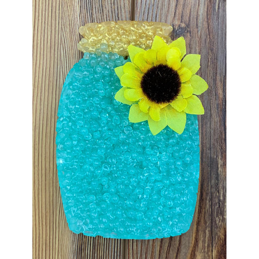 turquoise mason jar car freshie with sunflower on wood background