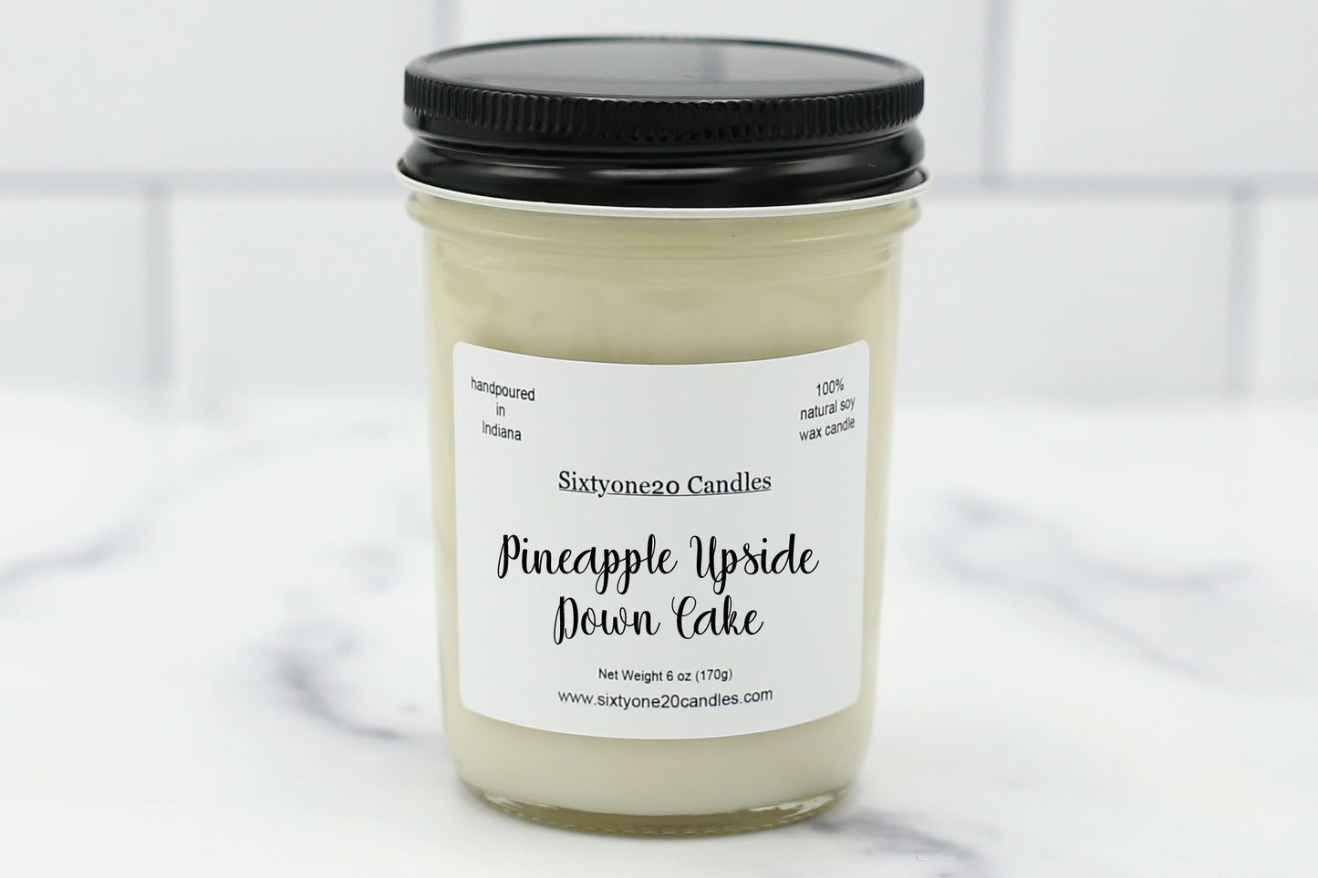 Jelly jar candle labeled “Pineapple Upside Down Cake” with natural soy wax and a tropical dessert scent of pineapple and vanilla cake.