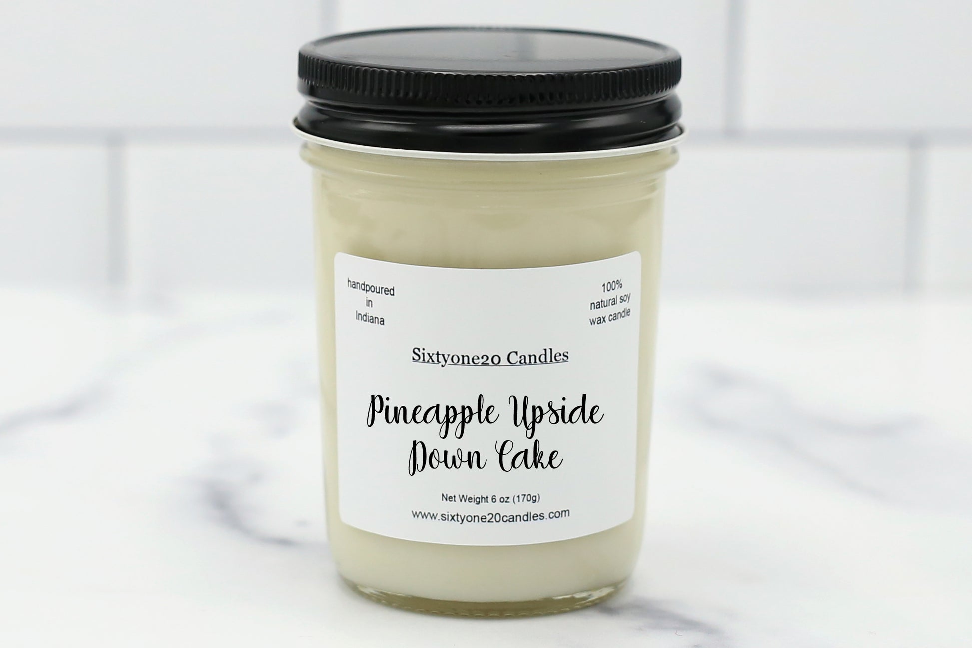 Jelly jar candle labeled “Pineapple Upside Down Cake” with natural soy wax and a tropical dessert scent of pineapple and vanilla cake.