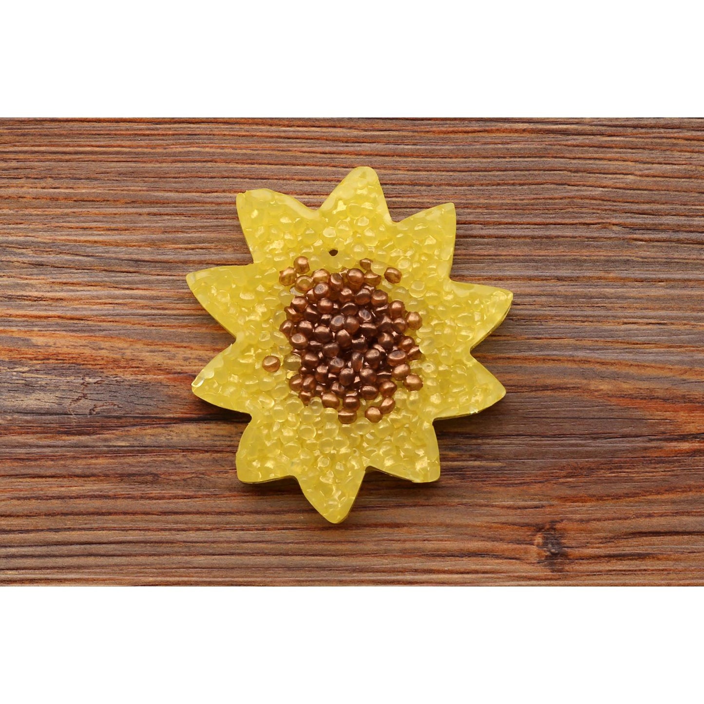 yellow sunflower car freshie with brown center on wood background